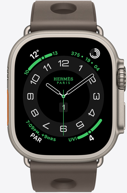 Apple Watch Hermès Ultra 3, titanium case, natural colour, Hermès Circulaire watch face, complications: weather, activity rings, PAR, UV index, right side exterior, Digital Crown, microphone, raised side button, Scub'H Diving band, gris titane colour
