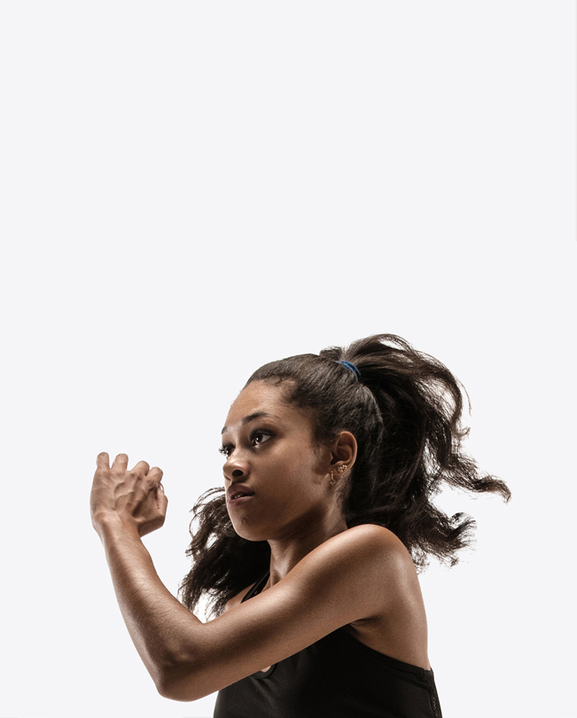 An Apple employee with a ponytail, mid-motion while exercising.