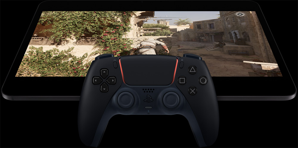 iPad Pro in landscape orientation, screen displaying a video game, PlayStation controller in front of the iPad