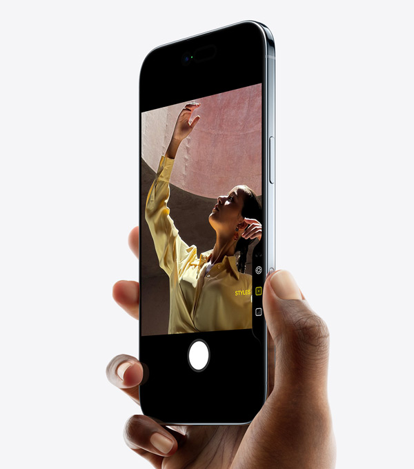 A hand holding iPhone Air with thumb on Camera Control button, front exterior, side exterior, thin profile, Dynamic Island, side button