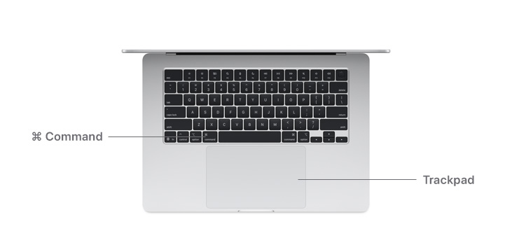 Desk view of MacBook Air M4 Command key button and trackpad.